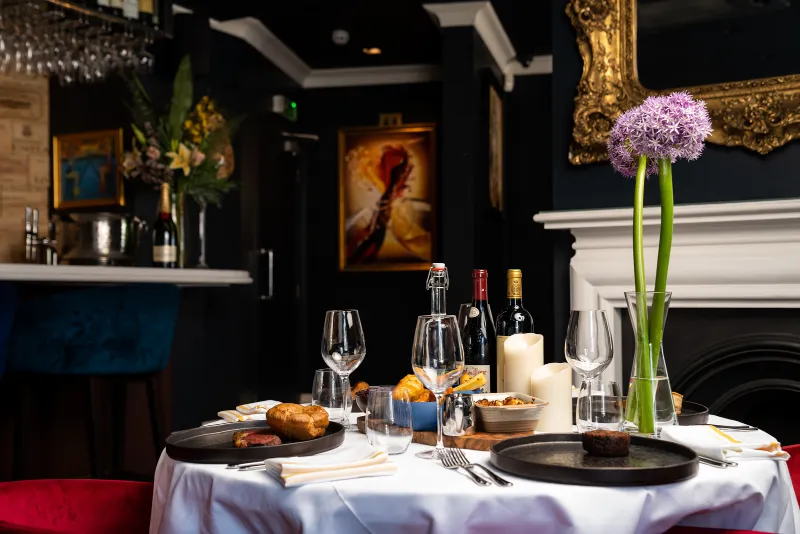 A table set by the fireplace at CuVée VIII