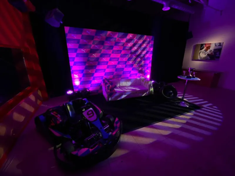 A motorbike displayed in purple light against a glowing wall