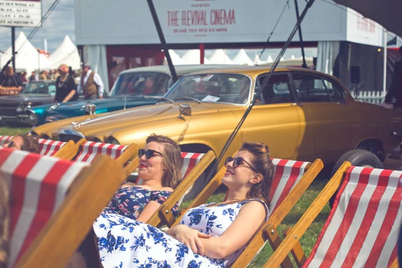 Striped deckchairs beside a vintage car, Goodwood Revival