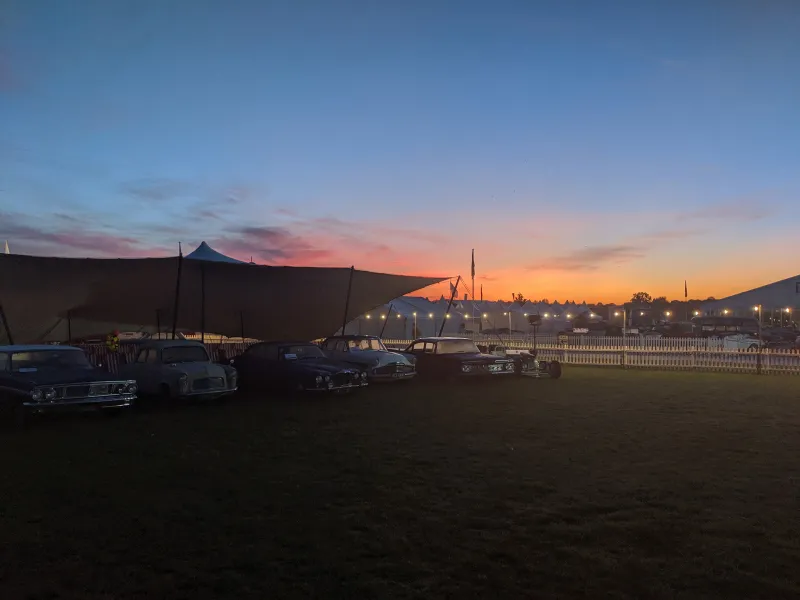 Sunset over the stretch tent and vintage cars, Goodwood Revival