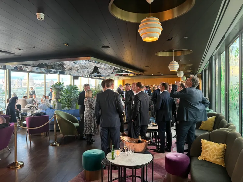 A reception in a lounge with city views