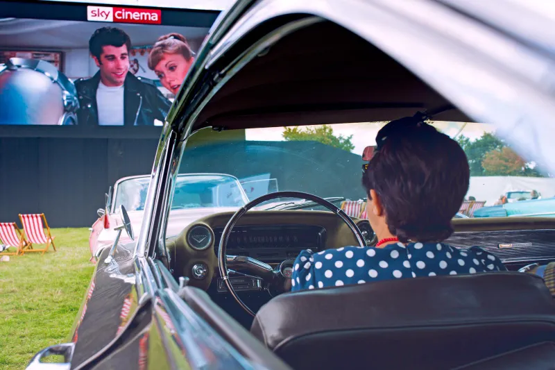 Grease on the big screen, seen from the driver’s seat of a vintage car: Sky Cinema at the Goodwood Revival